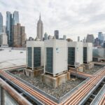 Commercial VRF outdoor condensing units installed on a Manhattan rooftop with NYC skyline in the background